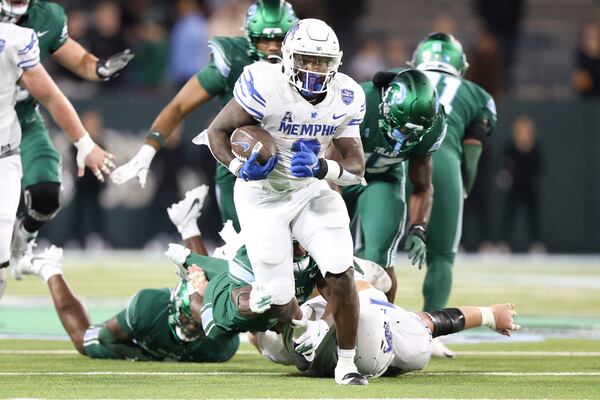 Memphis running back Mario Anderson Jr. (2) breaks a tackle en route to a 29-yard touchdown run to put the game away in the second half of an NCAA college football game in New Orleans, Thursday, Nov. 28, 2024. (AP Photo/Peter Forest)