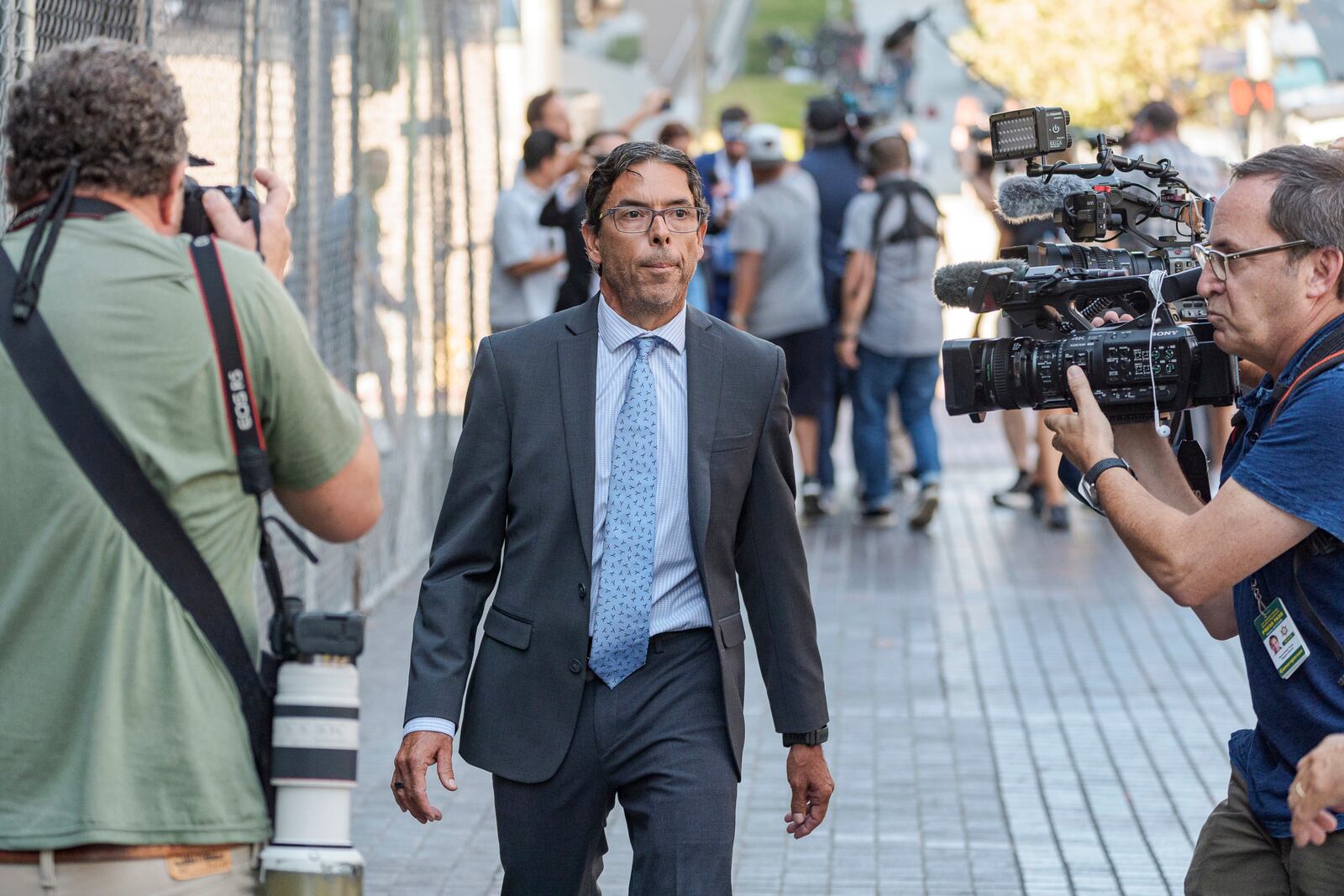 Dr. Mark Chavez, a physician from San Diego, who is charged in connection with Matthew Perry's fatal overdose, walks ahead of his with his criminal defense attorney, Matthew Binninger, seen in rear after pleading guilty to conspiring to distribute the surgical anesthetic ketamine in Los Angeles on Wednesday, Oct. 2, 2024. (AP Photo/Damian Dovarganes)