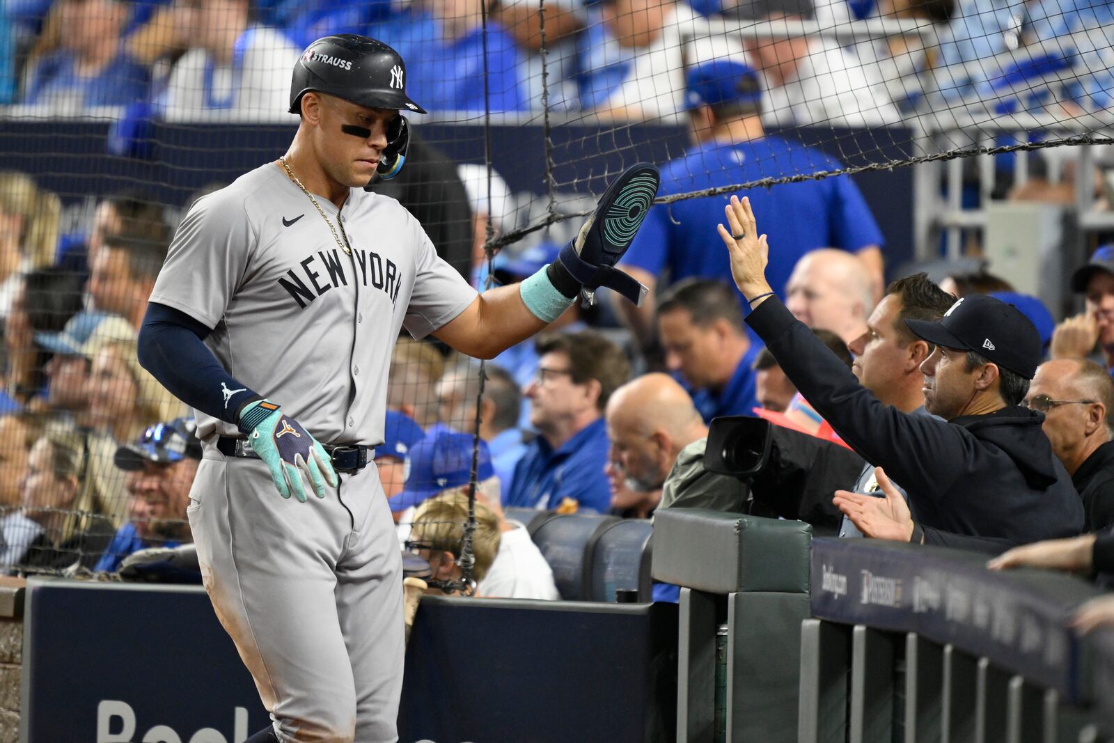 New York Yankees' Aaron Judge is congratulated by teammates after scoring during the sixth inning in Game 4 of an American League Division baseball playoff series against the Kansas City Royals Thursday, Oct. 10, 2024, in Kansas City, Mo. (AP Photo/Reed Hoffmann)