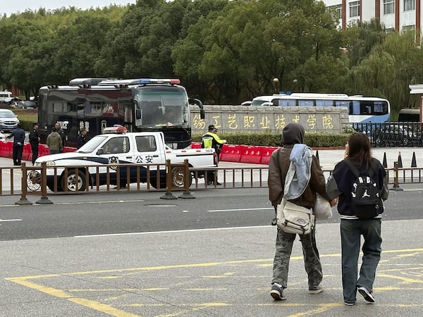 Police vehicles part in front of the Wuxi Vocational Institute of Arts and Technology in Yixing, eastern Chinese city of Wuxi Sunday, Nov. 17, 2024, a day after a stabbing attack took place. (Kyodo News via AP)