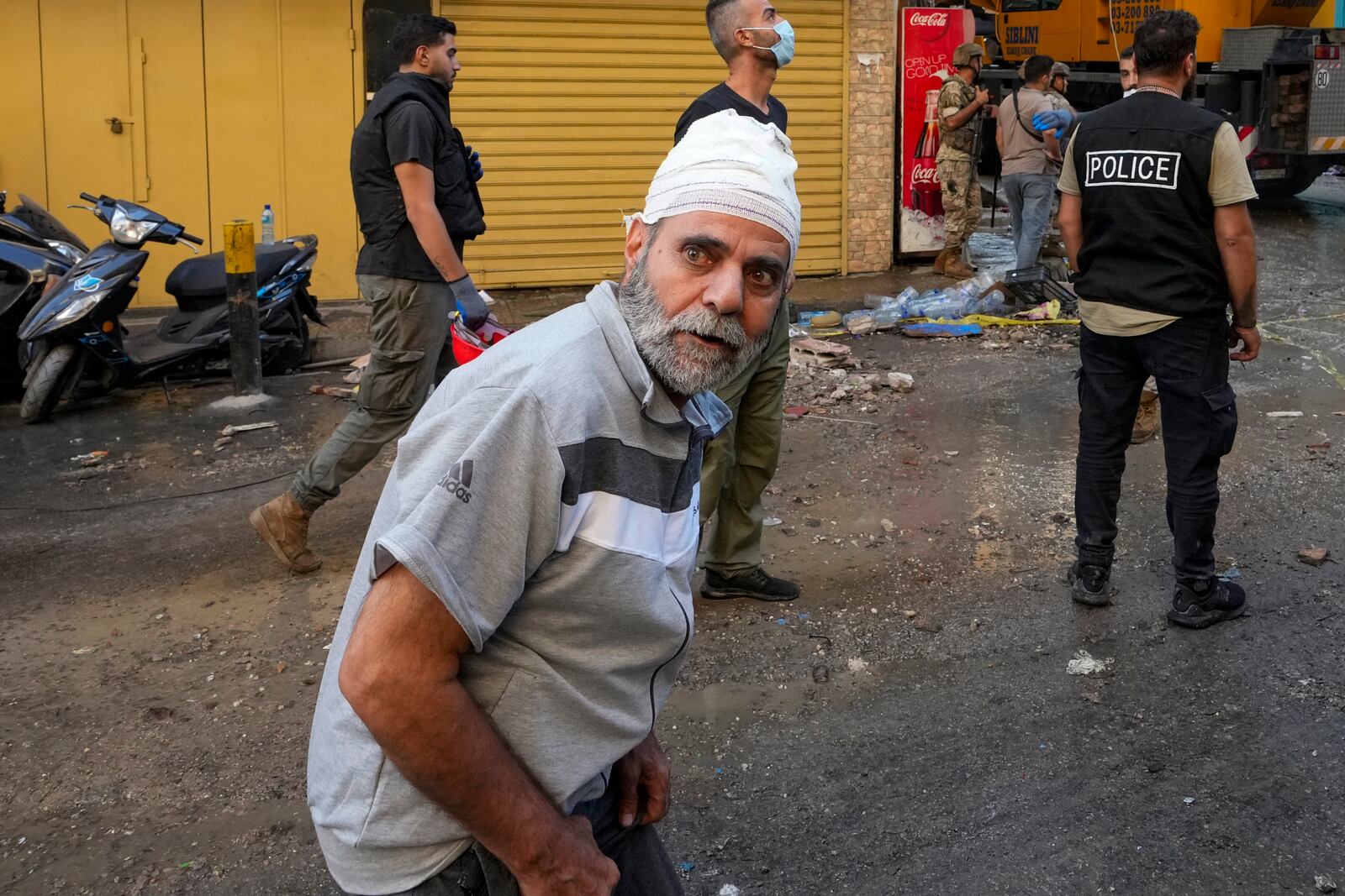 A wounded man reacts at the scene of the building that was hit by an Israeli airstrike in Beirut's southern suburbs, Tuesday, Sept. 24, 2024. (AP Photo/Hassan Ammar)