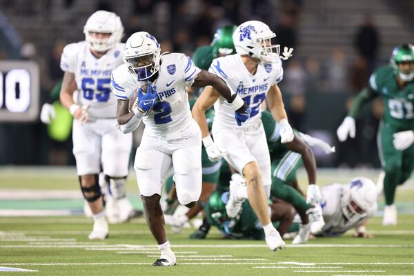 Memphis running back Mario Anderson Jr. (2) breaks a tackle en route to a touchdown run in the second half of an NCAA college football game in New Orleans, Thursday, Nov. 28, 2024. (AP Photo/Peter Forest)