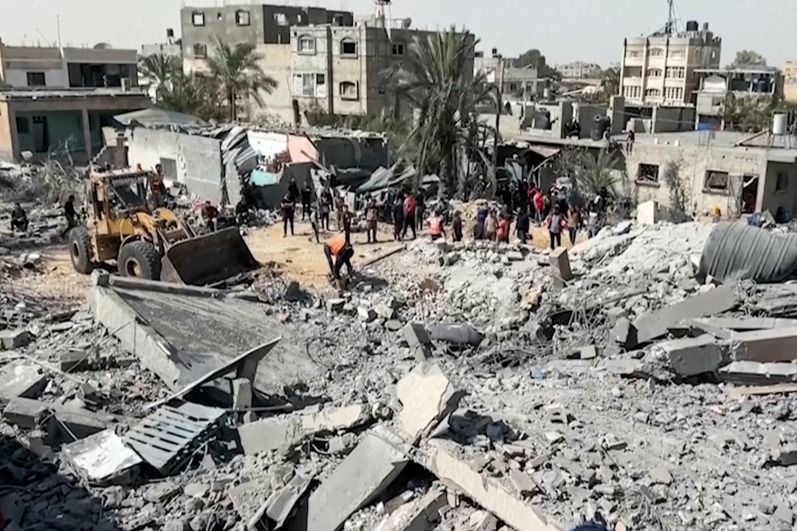 Palestinians gather near a building destroyed by Israeli airstrikes in the city of Khan Younis, southern Gaza Strip, Friday, Oct. 25, 2024. (AP Photo)