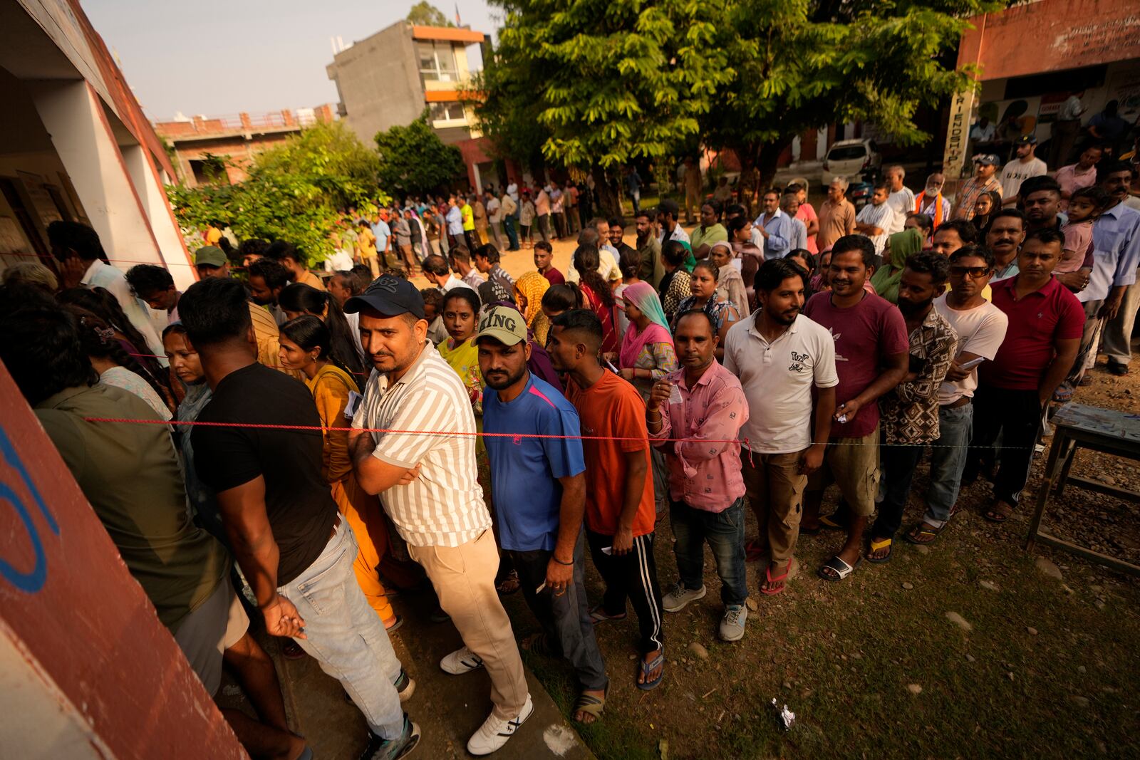 People queue up to cast their vote at a polling booth during the third phase of the Jammu and Kashmir Assembly election in Jammu, India, Tuesday, Oct. 1, 2024. (AP Photos/Channi Anand)