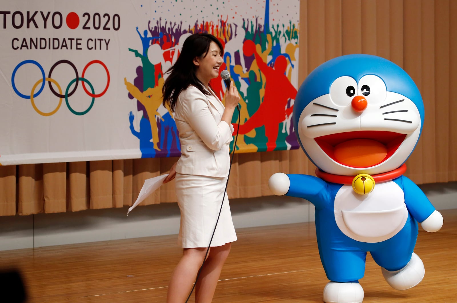 FILE - Doraemon, one of the most popular animation characters in Japan, participates in a kick-off ceremony of the Tokyo's bid to host the 2020 Olympics in Tokyo when Tokyo is bidding against Istanbul and Madrid to host the 2020 Olympics on Aug. 23, 2013. (AP Photo/Koji Sasahara, File)