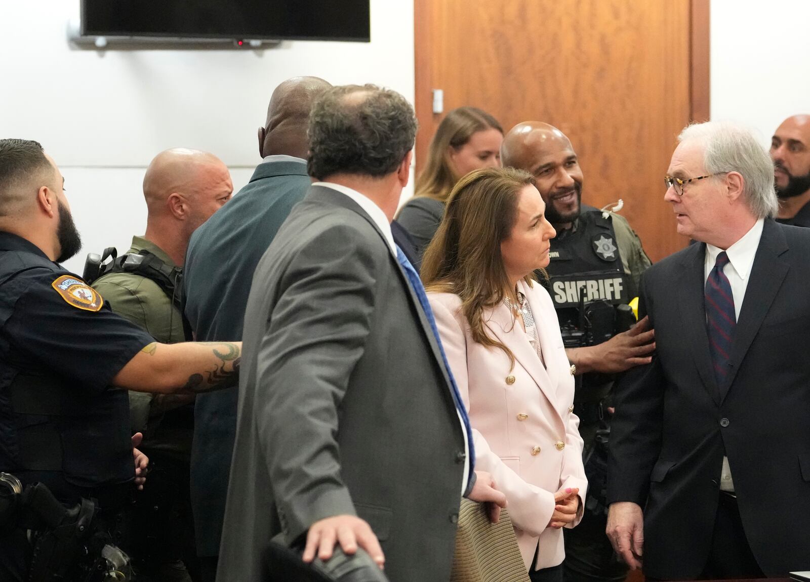 Defense attorney Mac Secrest, right, exchanges words with Harris County Sheriff's Deputies as he doesn't want his client former Houston police officer Gerald Goines, rear center left, removed before the jury has left the courtroom after a guilty verdict in the murder trial in the 482nd District Court at the Harris County Criminal courthouse Wednesday, Sept. 25, 2024, in Houston. (Melissa Phillip/Houston Chronicle via AP, Pool)