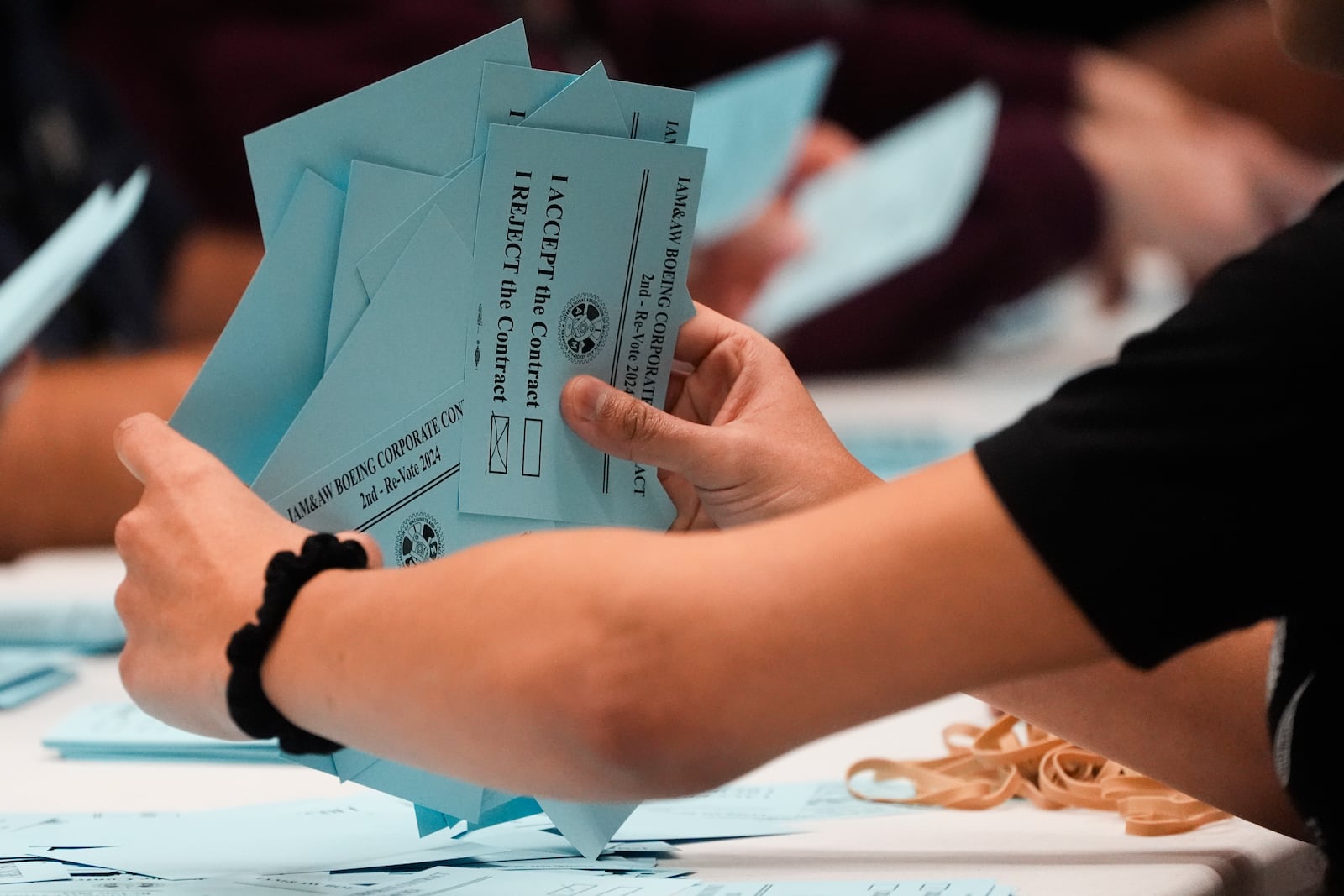 A volunteer sorts votes on a new contract offer from Boeing, Monday, Nov. 4, 2024, at the IAM District 751 Union Hall in Seattle. (AP Photo/Lindsey Wasson)