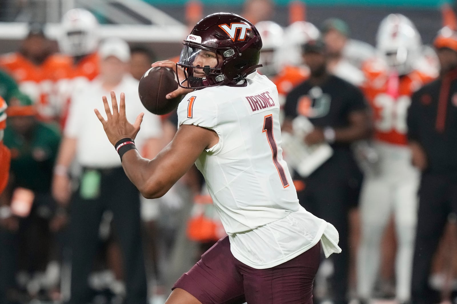 Virginia Tech quarterback Kyron Drones (1) aims a pass during the first half of an NCAA college football game against Miami, Friday, Sept. 27, 2024, in Miami Gardens, Fla. (AP Photo/Marta Lavandier)