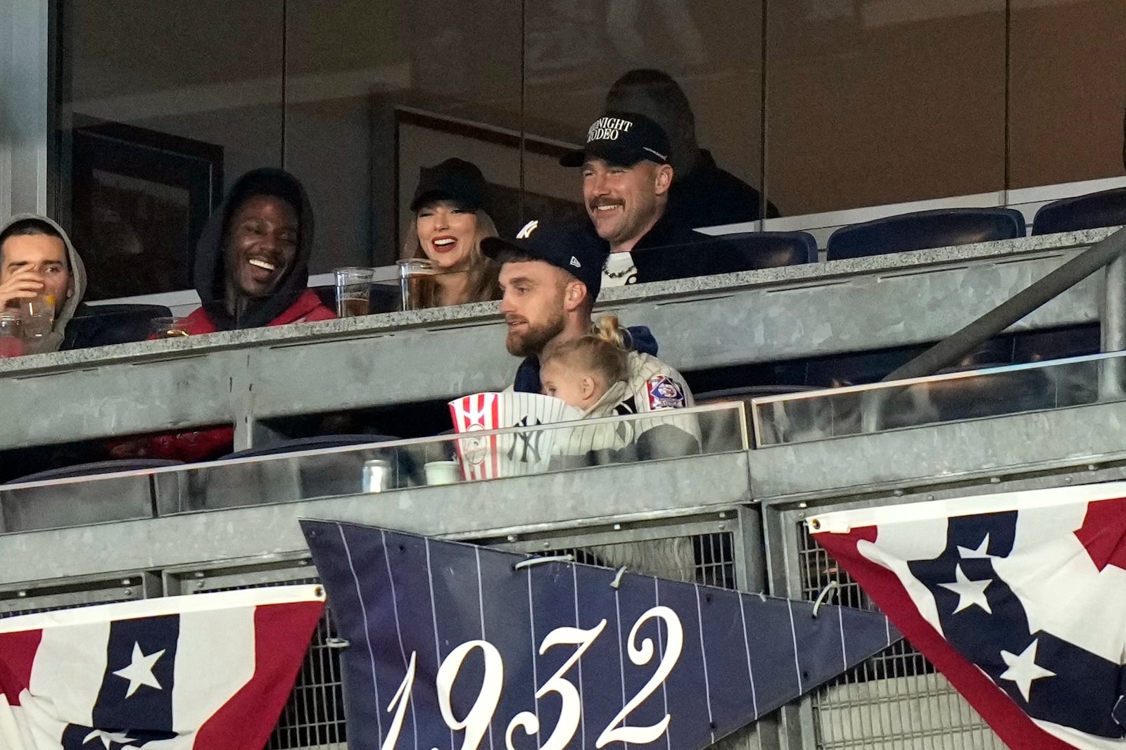 Travis Kelce, top right, and Taylor Swift watch Game 1 of the baseball AL Championship Series between the Cleveland Guardians and New York Yankees Monday, Oct. 14, 2024, in New York. (AP Photo/Frank Franklin II)