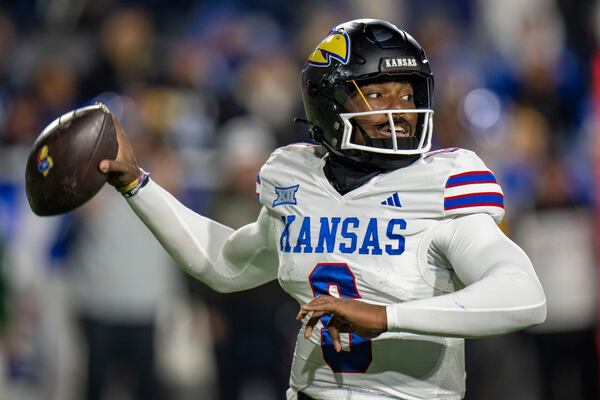 Kansas quarterback Isaiah Marshall throws a pass, during the first half of an NCAA college football game against BYU, Saturday, Nov. 16, 2024, in Provo. (AP Photo/Rick Egan)