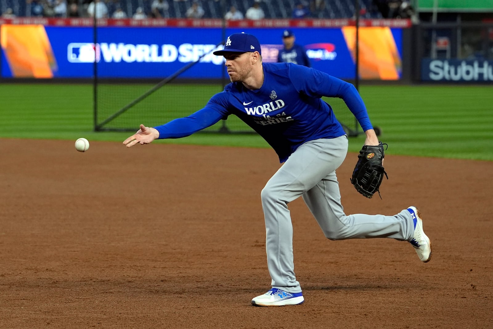 Los Angeles Dodgers first baseman Freddie Freeman tosses the ball during batting practic before Game 5 of the baseball World Series against the New York Yankees, Wednesday, Oct. 30, 2024, in New York. (AP Photo/Godofredo A. Vásquez)