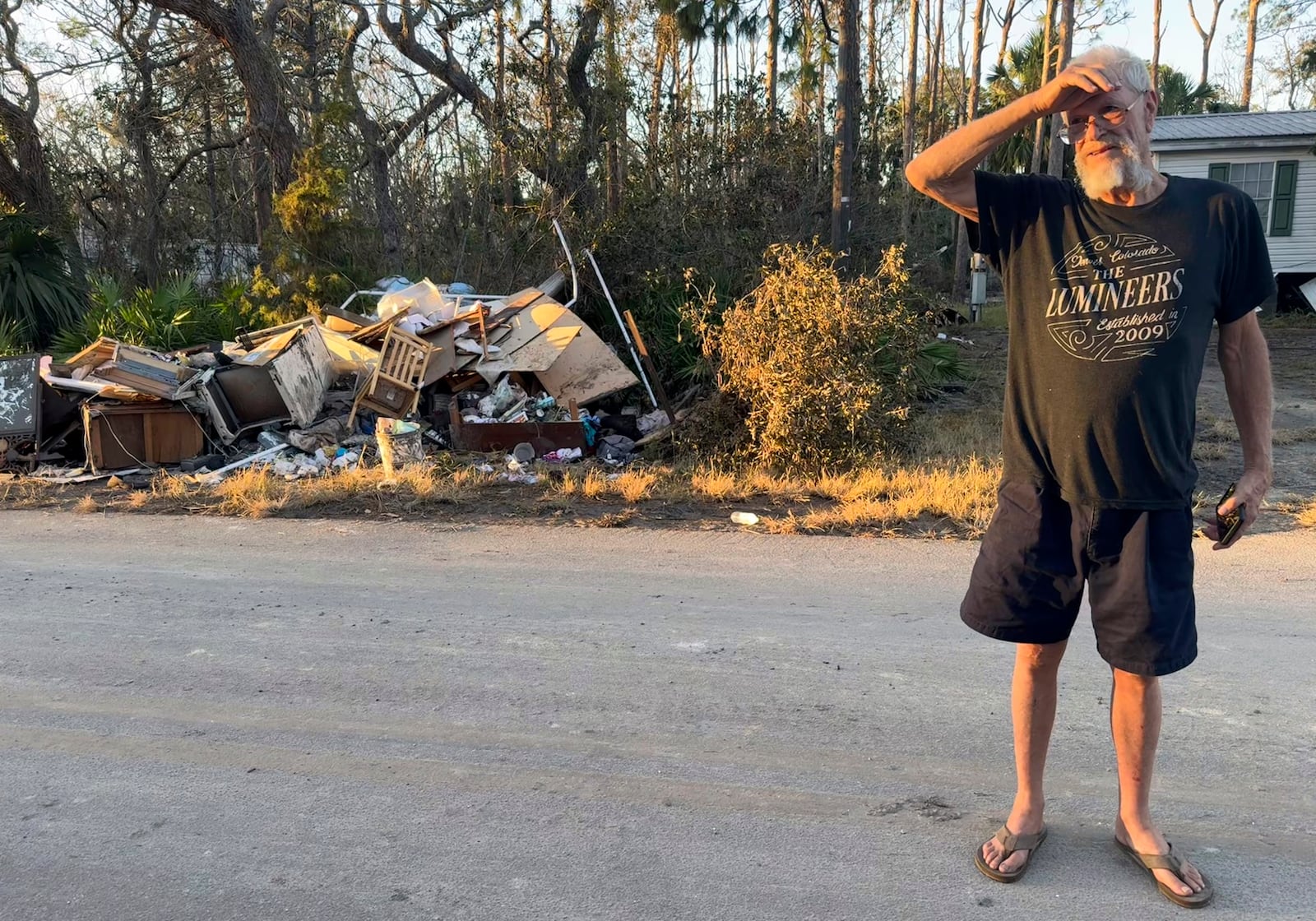 Dave Beamer surveys debris left behind by Hurricane Helene along his street in Steinhatchee, Fla., Sunday. Sept. 29, 2024. Beamer had just rebuilt his home in the wake of Hurricane Idalia in August 2023, before Helene washed it into a marsh. (AP Photo/Kate Payne)