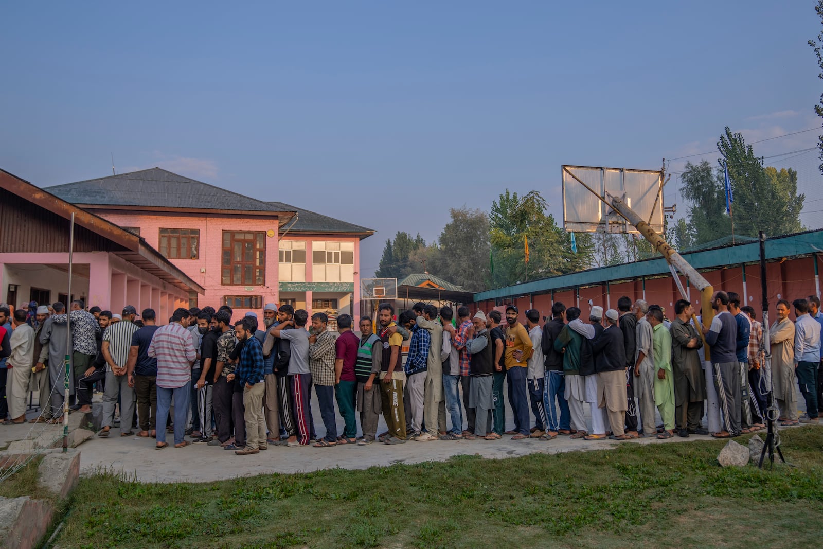 Kashmiri's queue up at a polling booth to cast their vote during the second phase of the assembly election in the outskirts of Srinagar, Indian controlled Kashmir, Wednesday, Sept. 25, 2024. (AP Photo/Dar Yasin)