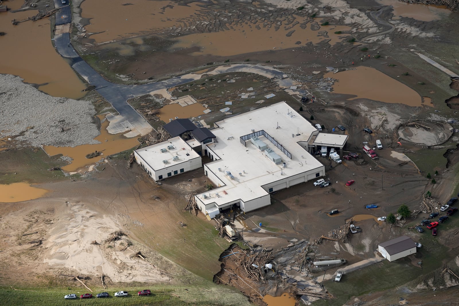 An aerial view of flood-damaged Unicoi County Hospital in the aftermath of Hurricane Helene, Saturday, Sept. 28, 2024, in Erwin, Tenn. (AP Photo/George Walker IV)