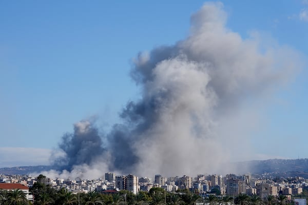 Smoke rises between buildings hit in Israeli airstrikes in Hosh neighbourhood, in Tyre, south Lebanon, Tuesday, Nov. 26, 2024. (AP Photo/Hussein Malla)