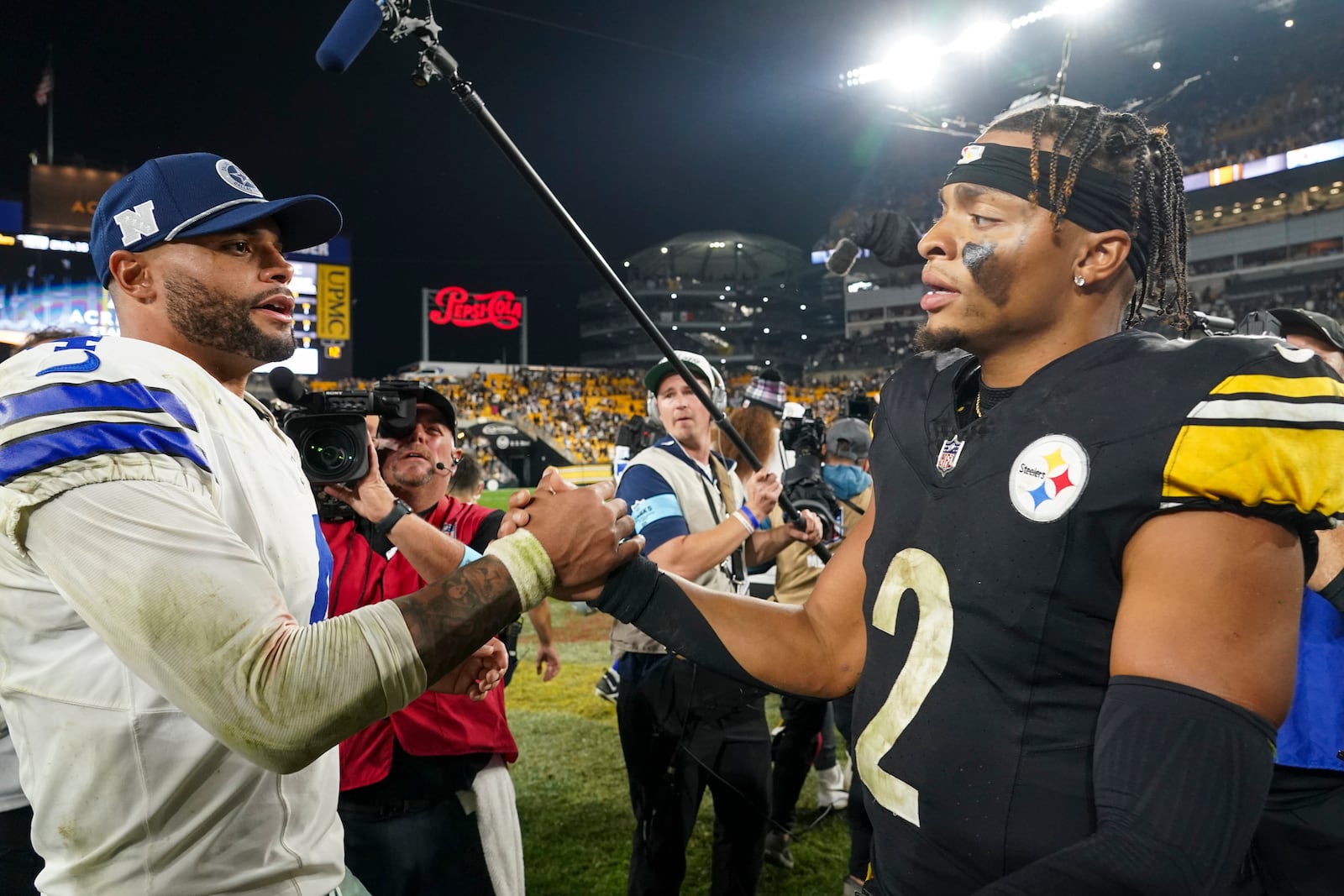 Dallas Cowboys quarterback Dak Prescott, left, talks with Pittsburgh Steelers quarterback Justin Fields following an NFL football game, early Monday, Oct. 7, 2024, in Pittsburgh. The Cowboys won 20-17. (AP Photo/Matt Freed)