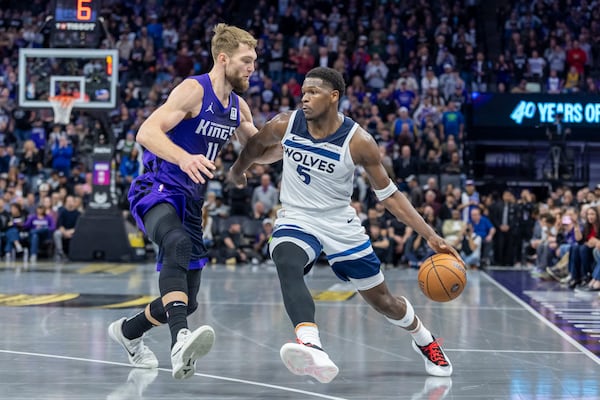 Minnesota Timberwolves guard Anthony Edwards (5) drives to the basket as Sacramento Kings forward Domantas Sabonis (11) defends during overtime of an Emirates NBA Cup basketball game Friday, Nov. 15, 2024, in Sacramento, Calif. (AP Photo/Sara Nevis)