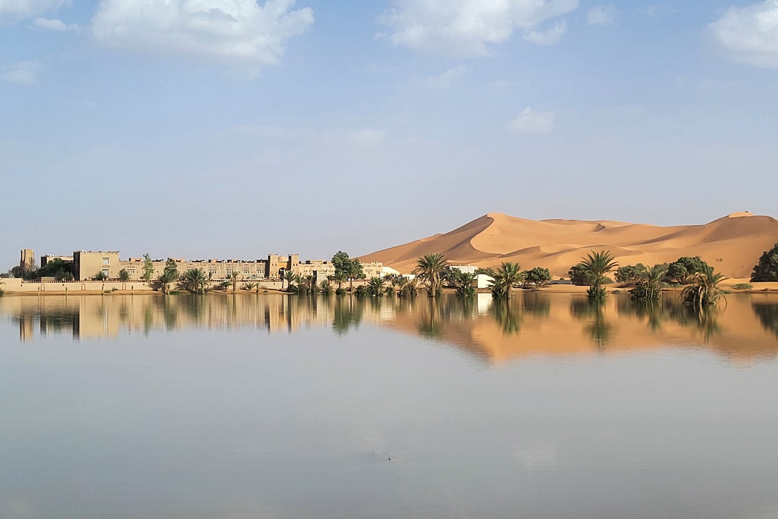 An oasis is reflected in a lake caused by heavy rainfall in the desert town of Merzouga, near Rachidia, southeastern Morocco, Wednesday, Oct. 2, 2024. (AP Photo)