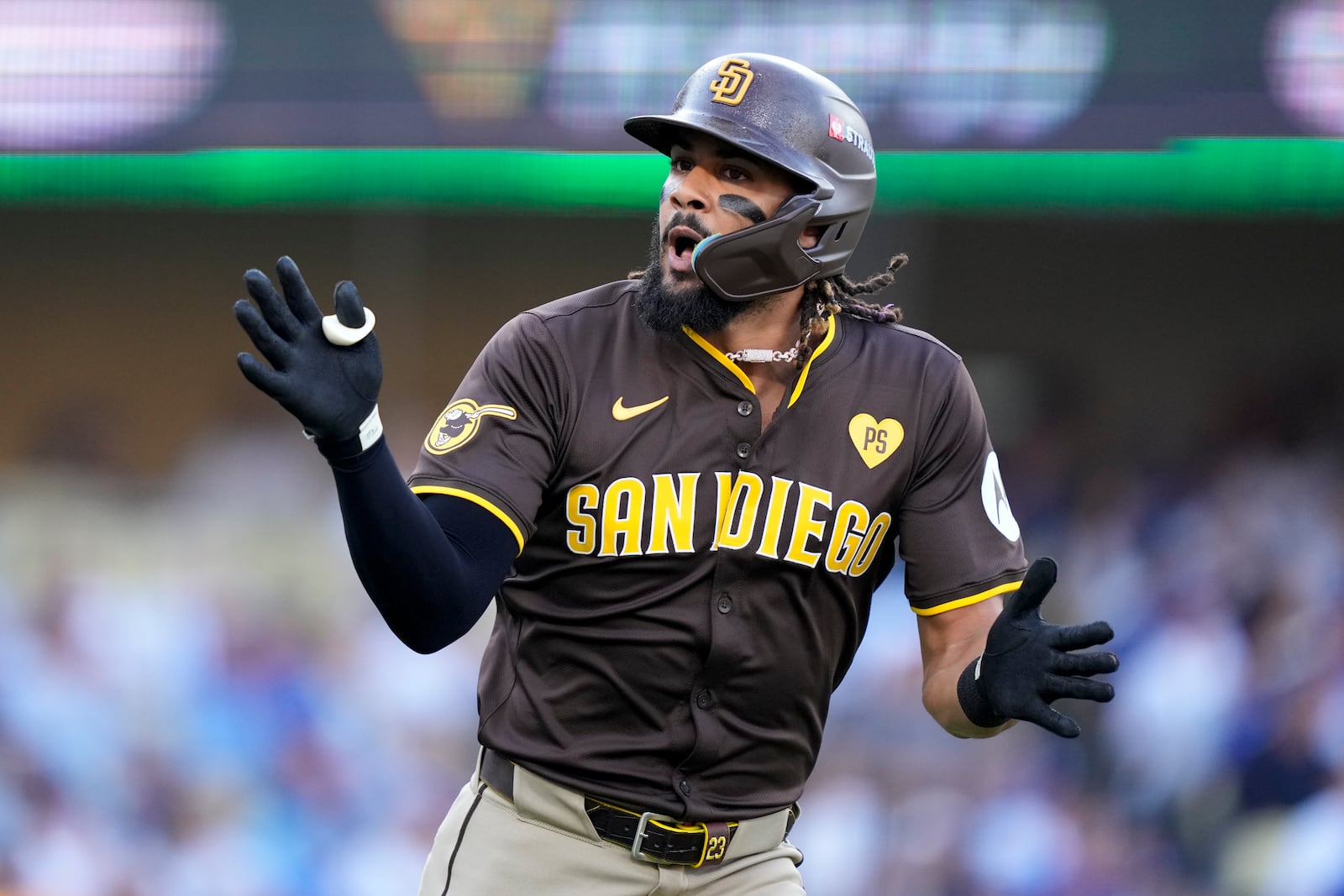 San Diego Padres' Fernando Tatis Jr. celebrates as he rounds first base after a solo home run during the first inning in Game 2 of a baseball NL Division Series against the Los Angeles Dodgers, Sunday, Oct. 6, 2024, in Los Angeles. (AP Photo/Mark J. Terrill)