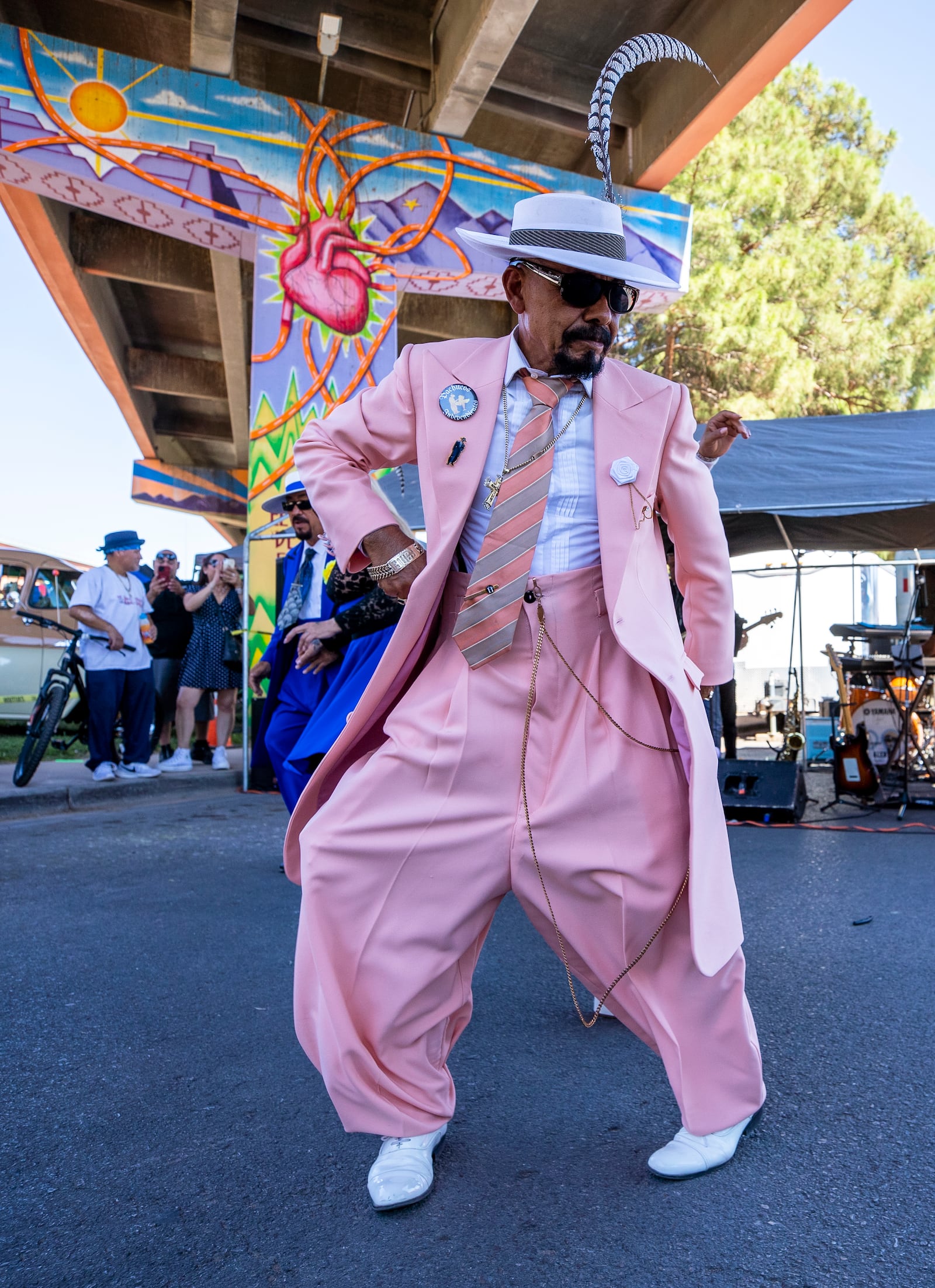 Hugo Cardenas, wearing a Zoot suit of the Mexican American subculture known as Pachucos, dances while attending a lowrider exhibition during the 20th anniversary of Lincoln Park in El Paso, Texas, Sunday, Sept. 22, 2024. (AP Photo/Andrés Leighton)