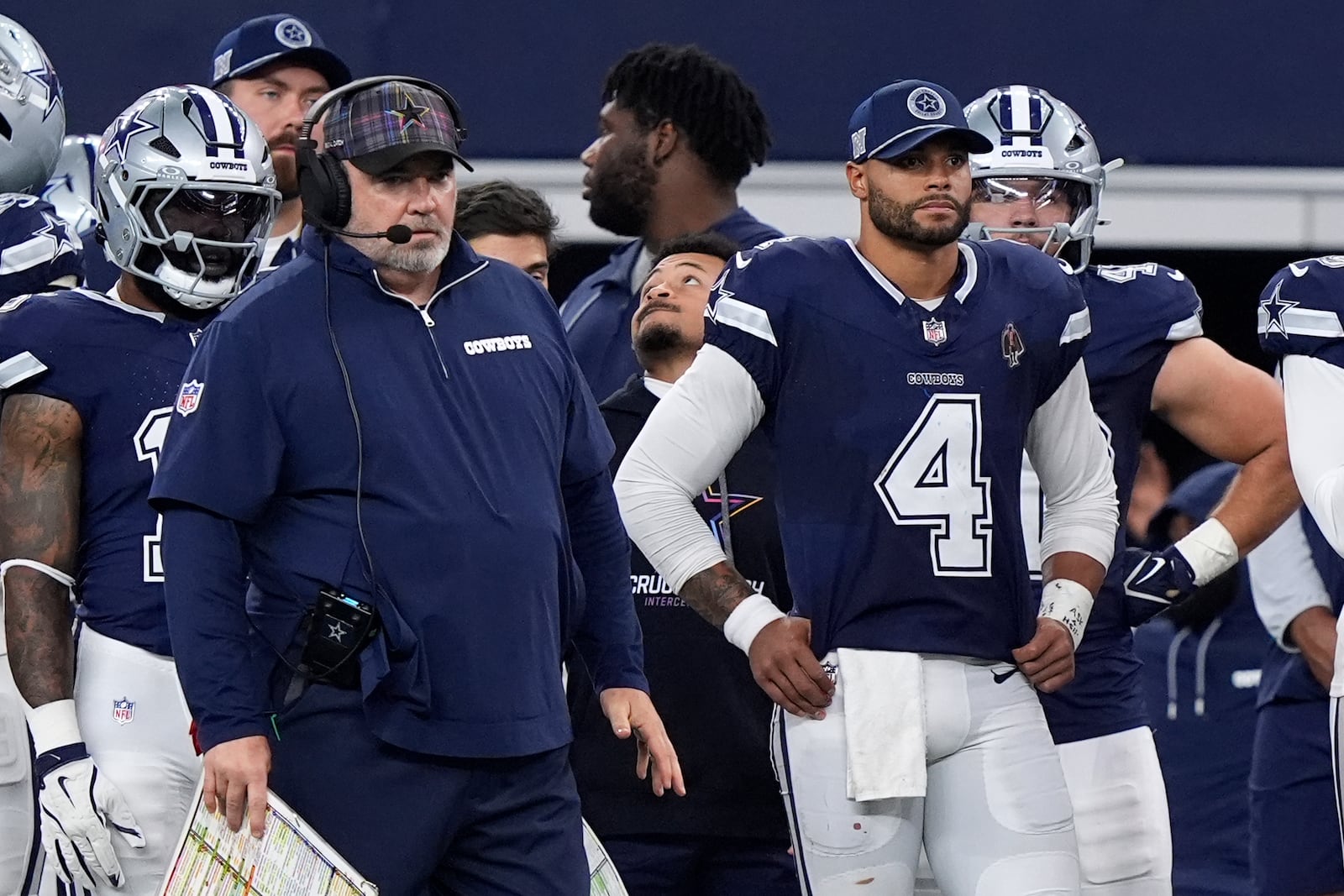 Dallas Cowboys head coach Mike McCarthy, left, and quarterback Dak Prescott (4) watch play against the Detroit Lions in the second half of an NFL football game in Arlington, Texas, Sunday, Oct. 13, 2024. (AP Photo/LM Otero)