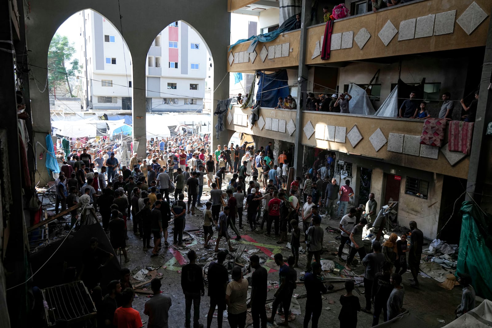 Palestinians inspect the damage of a school hit by an Israeli bombardment on Deir al-Balah, central Gaza Strip, Thursday, Oct. 10, 2024. (AP Photo/Abdel Kareem Hana)