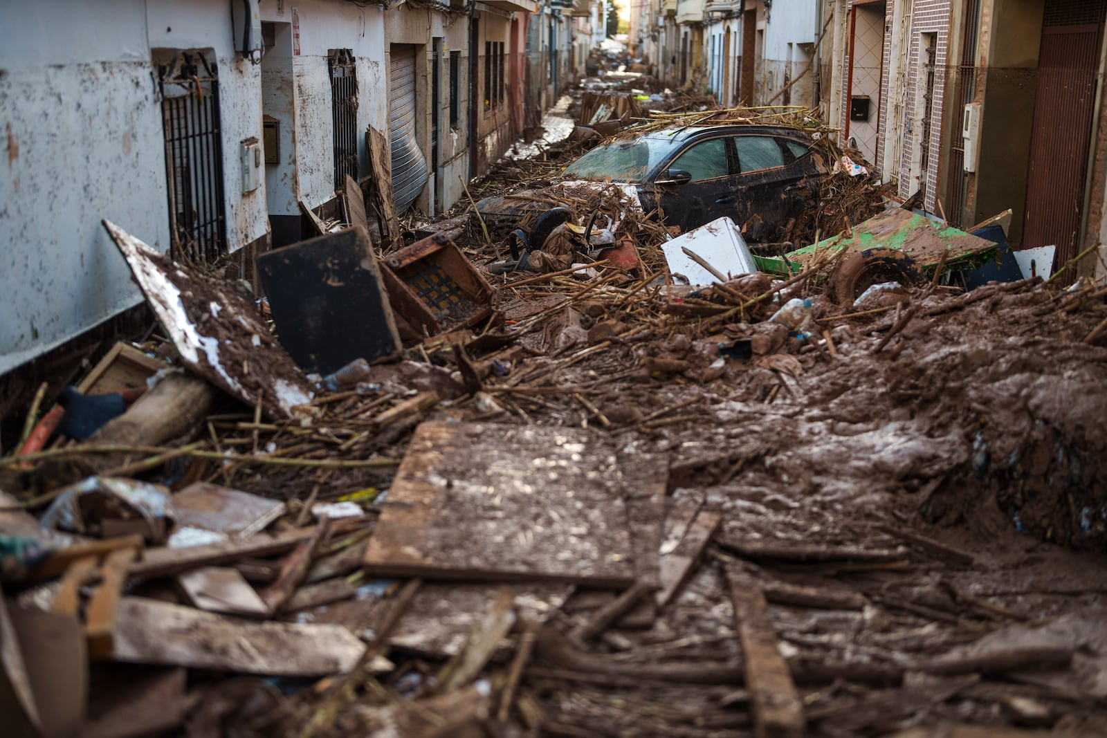 A street covered with mud and debris in an area affected by floods in Valencia, Spain, Saturday, Nov. 2, 2024. (AP Photo/Manu Fernandez)