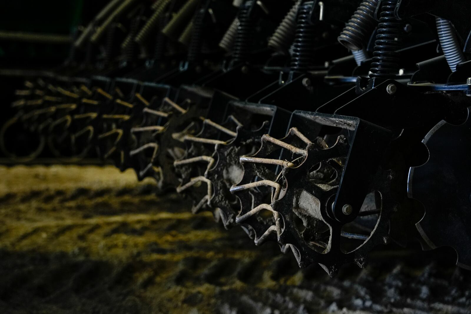 A strip-till tractor, used to plant fertilizer deep into a field's soil, sits inside a garage, Tuesday, Aug. 27, 2024, at a farm in Forest, Ohio. (AP Photo/Joshua A. Bickel)