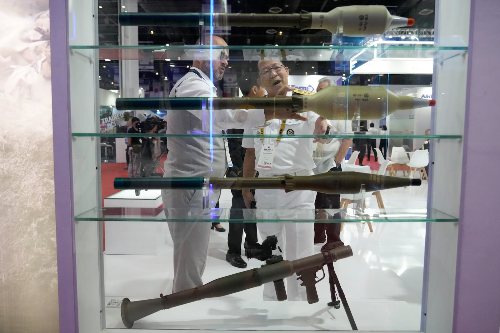 Philippine Navy Vice Commander Rear Adm. Jose Ma. Ambrosio Ezpeleta, right, talks with an exhibitor during the Asian Defense and Security Exhibition in Manila, Philippines, Wednesday, Sept. 25, 2024. (AP Photo/Aaron Favila)