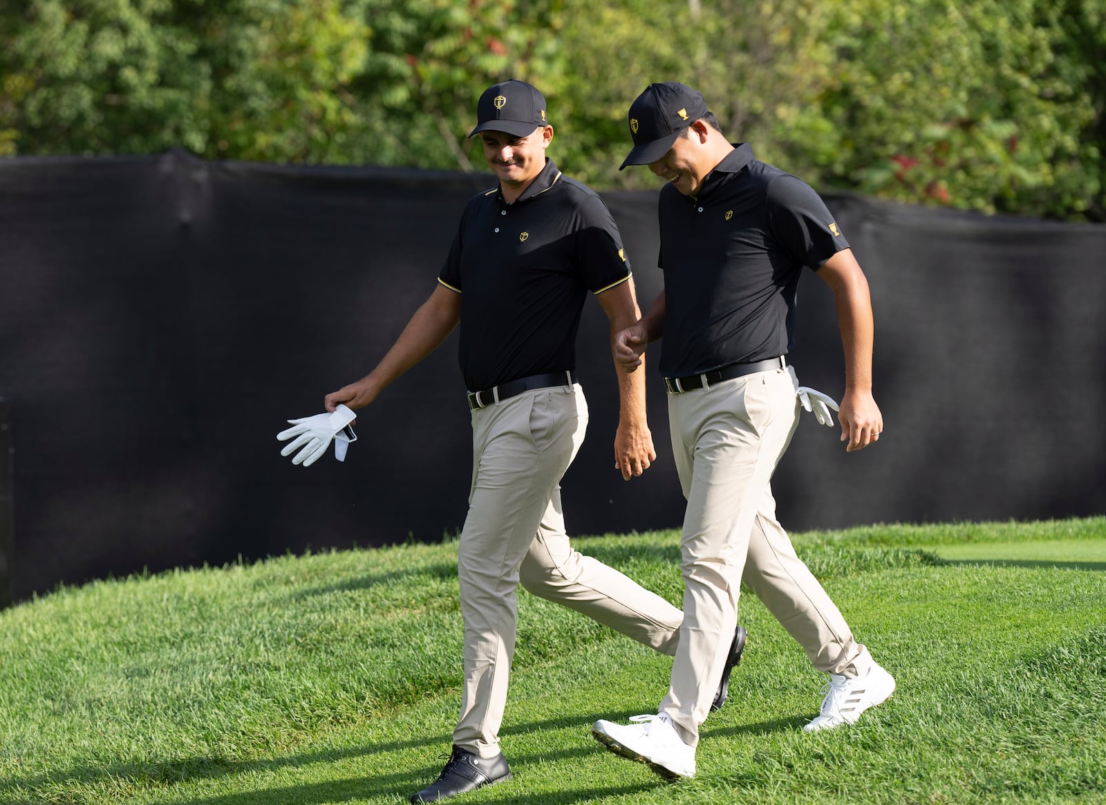 International team members Christiaan Bezuidenhout, of South Africa, left, and Si Woo Kim of South Korea, walk the fairway on the fourth hole during practice at the Presidents Cup golf tournament at Royal Montreal Golf Club in Montreal, Tuesday, Sept. 24, 2024. (Christinne Muschi/The Canadian Press via AP)