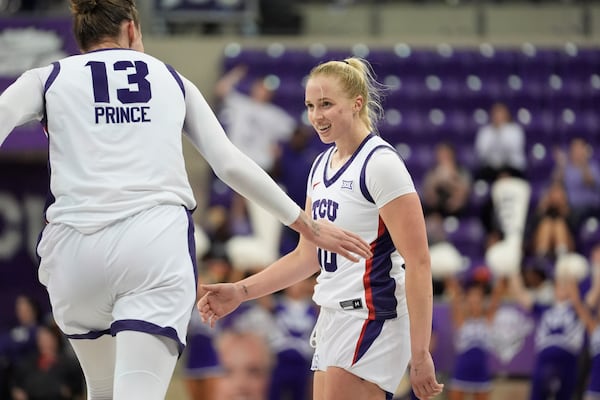 TCU guard Hailey Van Lith, right, is congratulated by teammate center Sedona Prince (13) during the second half of an NCAA college basketball game against Idaho State, Sunday, Nov. 24, 2024, in Fort Worth, Texas. (AP Photo/LM Otero)