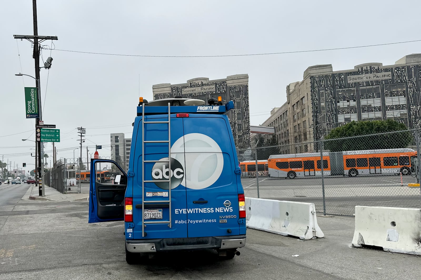 A news truck is parked near the scene of an overnight transit bus hijacking Wednesday, Sept. 25, 2024, in Los Angeles. (AP Photo/Ryan Sun)