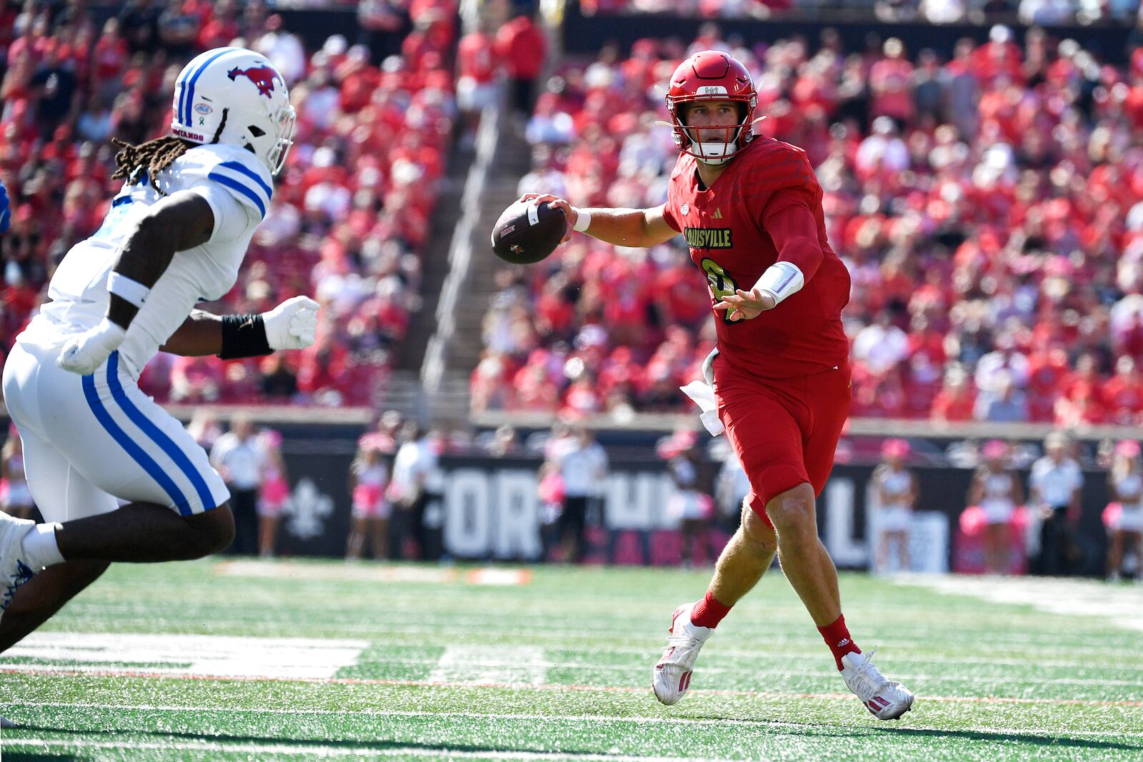 Louisville quarterback Tyler Shough (9) attempts a pass away from the pressure of SMU defensive end Jahfari Harvey (6) during the first half of an NCAA college football game in Louisville, Ky., Saturday, Oct. 5, 2024. (AP Photo/Timothy D. Easley)