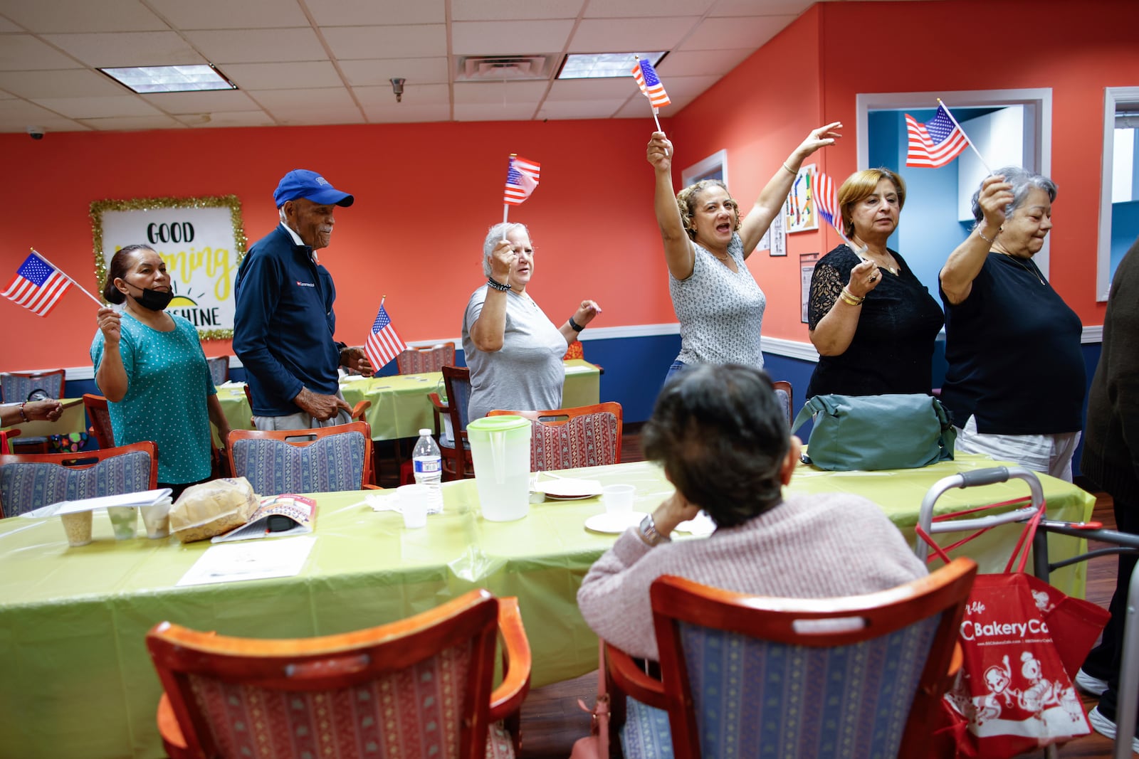 People march in a line as they take part in a multicultural parade at Sunshine Adult Day Center in Bergenfield, N.J., Monday, Aug. 26, 2024. (AP Photo/Kena Betancur)