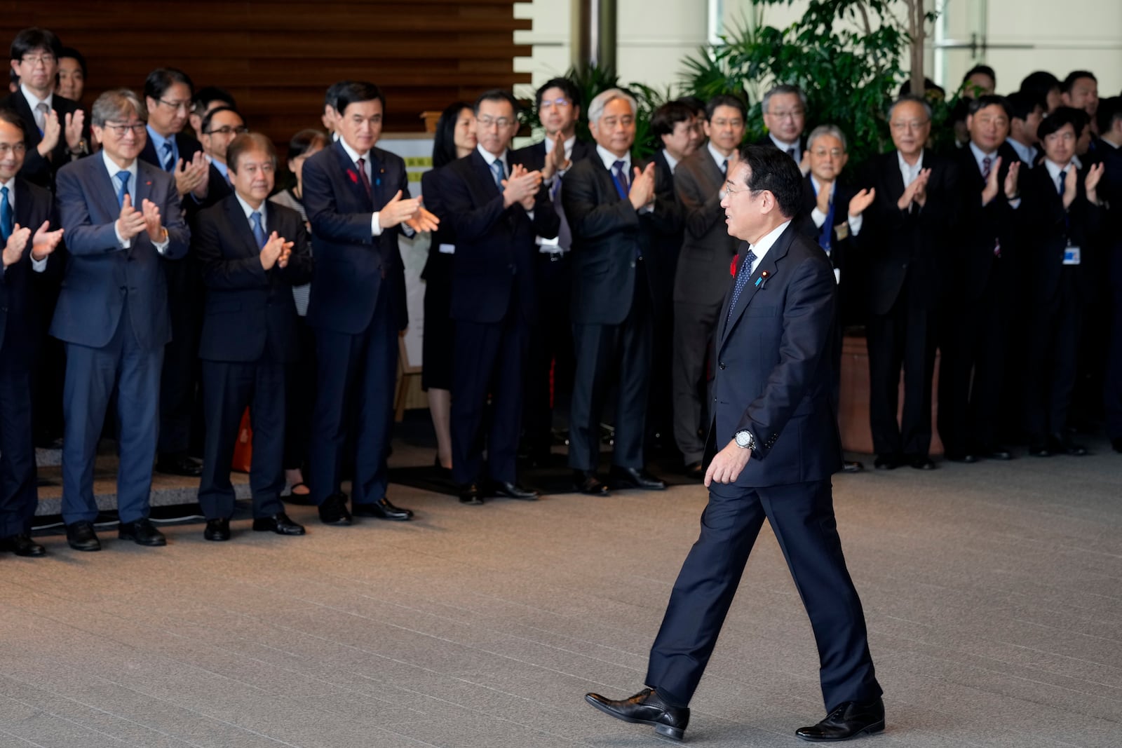 Japan's outgoing Prime Minister Fumio Kishida, front, is seen off as he leaves the prime minister's office in Tokyo Tuesday, Oct. 1, 2024. (AP Photo/Hiro Komae)