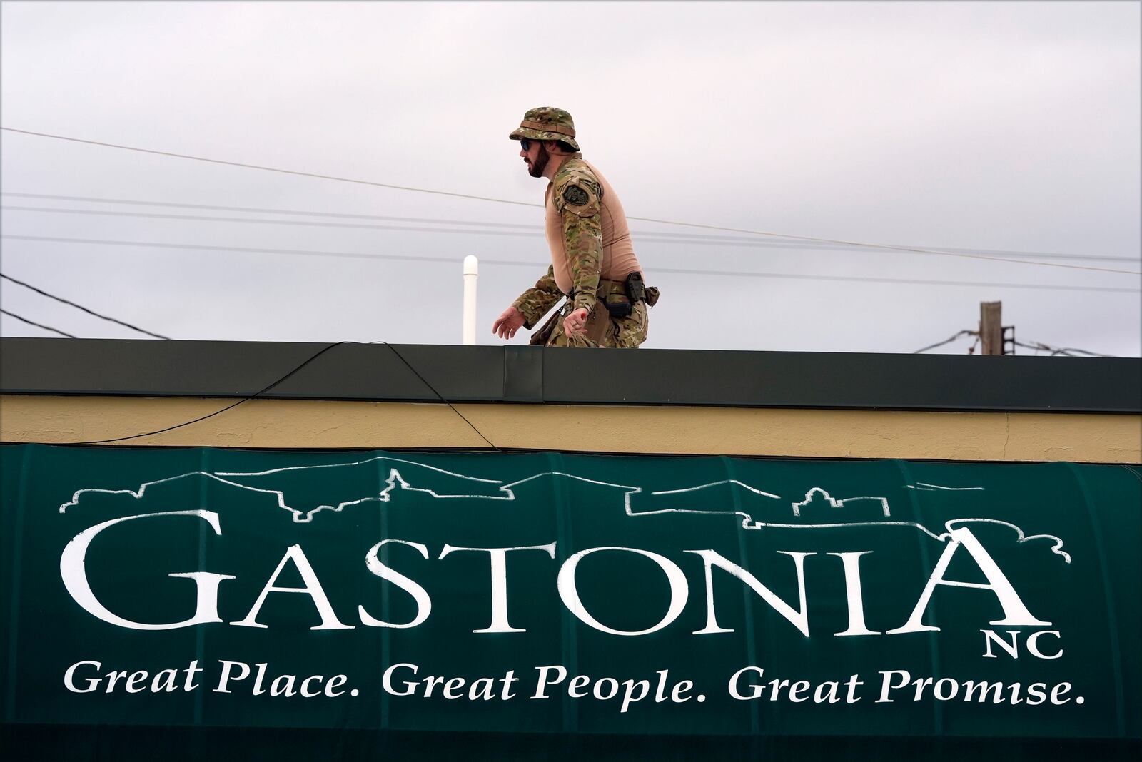 A member of law enforcement takes position before Republican presidential nominee former President Donald Trump speaks at a campaign rally in Gastonia, N.C., Saturday, Nov. 2, 2024. (AP Photo/Chris Carlson)