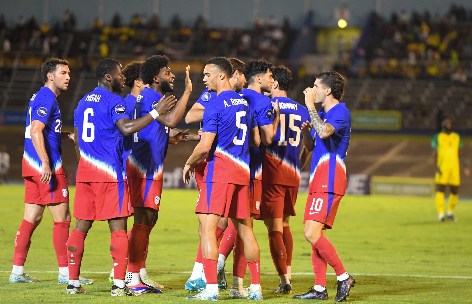 United States players celebrate scoring the opening goal against Jamaica during CONCACAF Nations League quarterfinal first leg soccer match in Kingston, Jamaica, Thursday, Nov. 14, 2024. (AP Photo/Collin Reid)