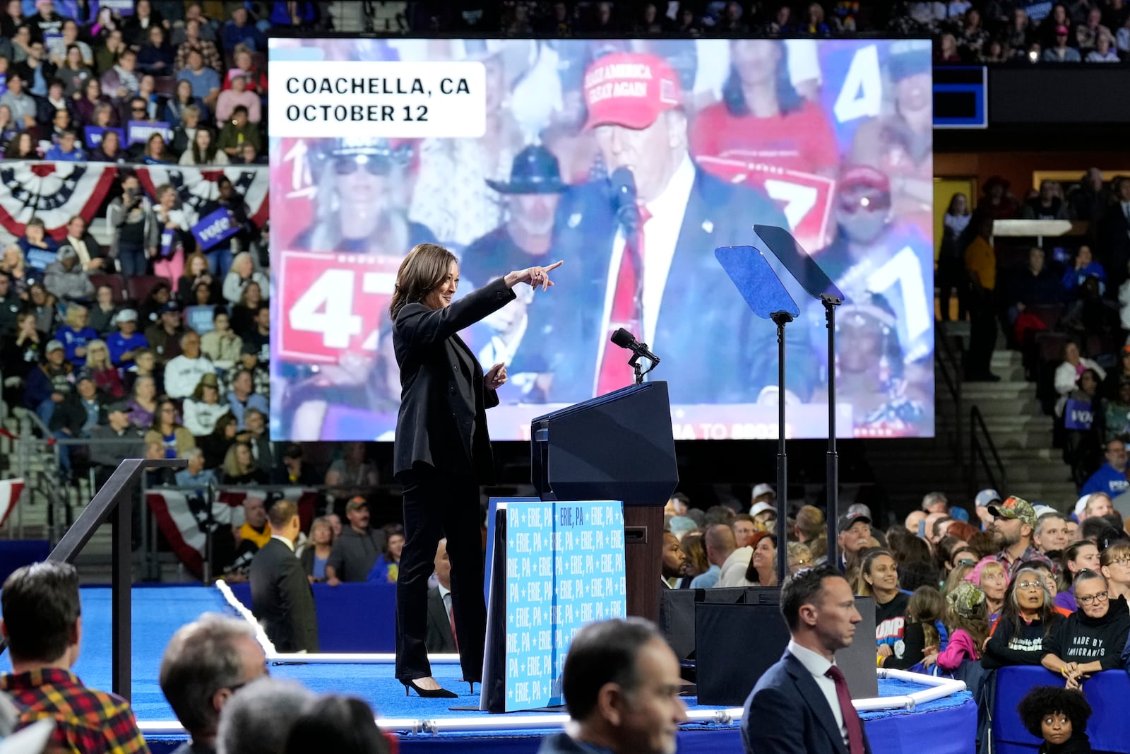 Democratic presidential nominee Vice President Kamala Harris speaks as an image of Republican presidential nominee former President Donald Trump appears on screen during a campaign rally at Erie Insurance Arena, in Erie, Pa., Monday, Oct. 14, 2024. (AP Photo/Jacquelyn Martin)