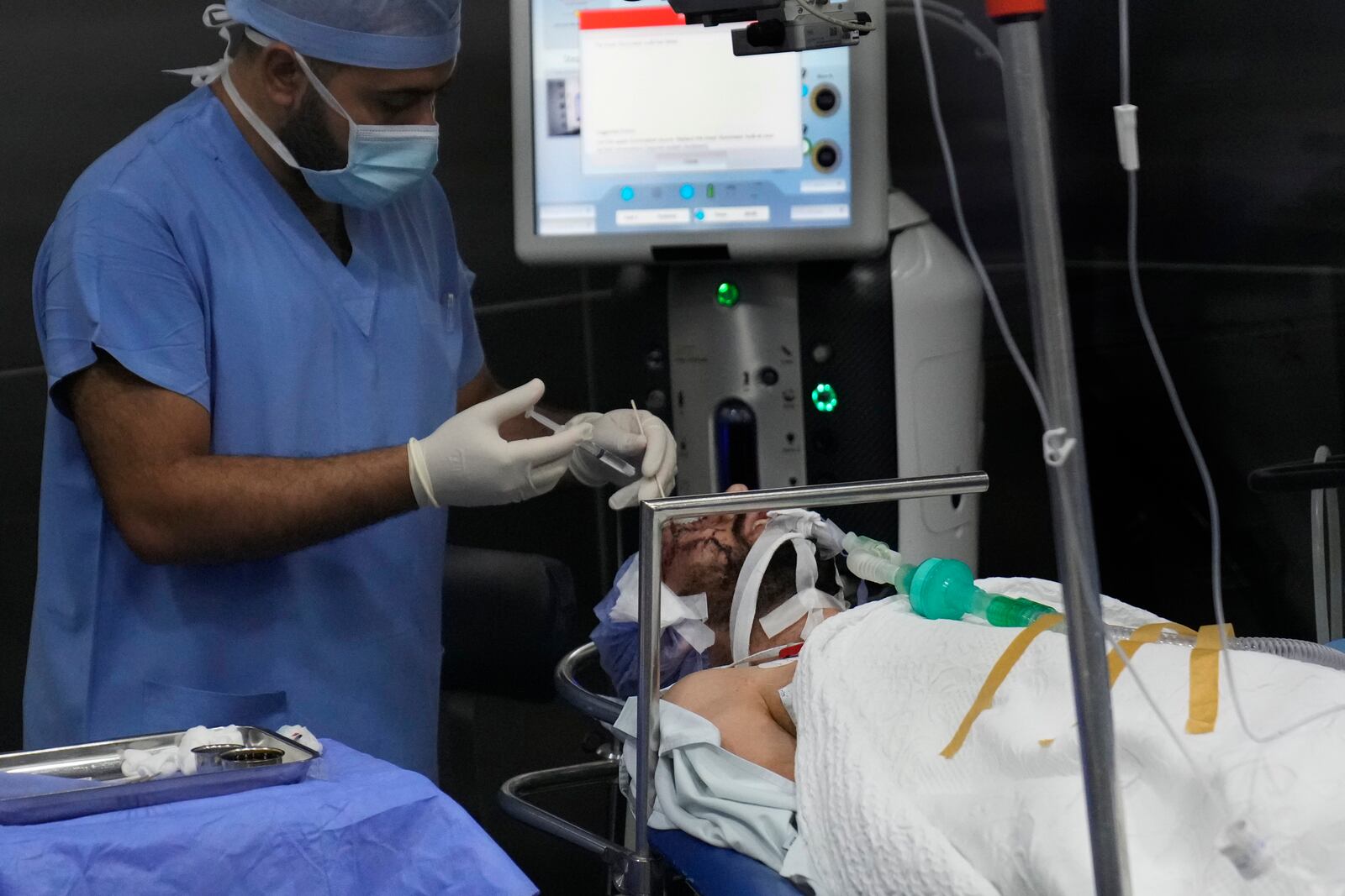 A man who was injured in the explosion of one of the handheld devices, lies inside an operation room ahead of an eye surgery at the Eye Specialist hospital, in Beirut, Lebanon, Friday, Sept. 20, 2024. (AP Photo/Hussein Malla)