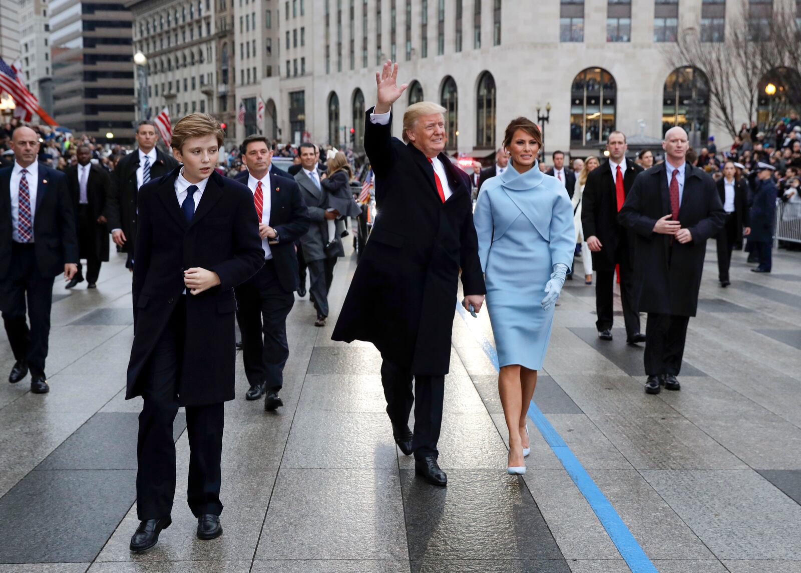 FILE - President Donald Trump waves as he walks with first lady Melania Trump and their son Barron, left, walk during the inauguration parade on Pennsylvania Avenue in Washington, Jan. 20, 2016. (AP Photo/Evan Vucci, Pool)