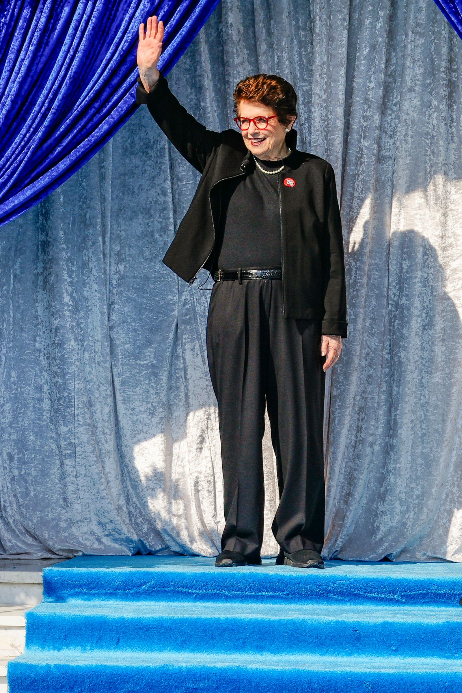 Tennis great Billie Jean King waves as she is introduced as grand marshal of the 136th Rose Parade next year on the front steps of the Tournament House in Pasadena, Calif., Monday, Oct. 7, 2024. (AP Photo/Damian Dovarganes)