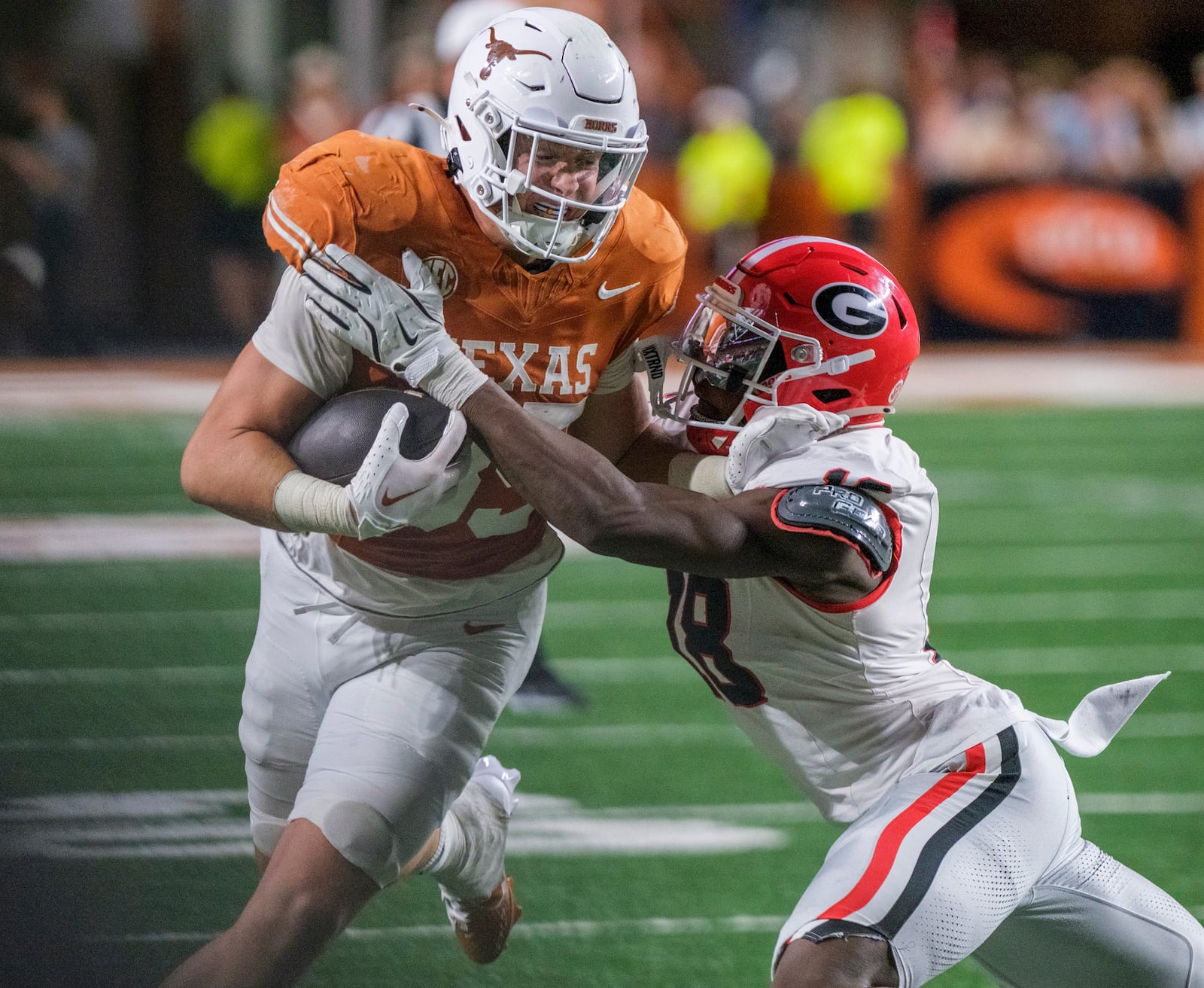 Texas tight end Gunnar Helm (85) is wrapped up by Georgia linebacker Chris Cole (18) during the second half of an NCAA college football game in Austin, Texas, Saturday, Oct. 19, 2024. (AP Photo/Rodolfo Gonzalez)