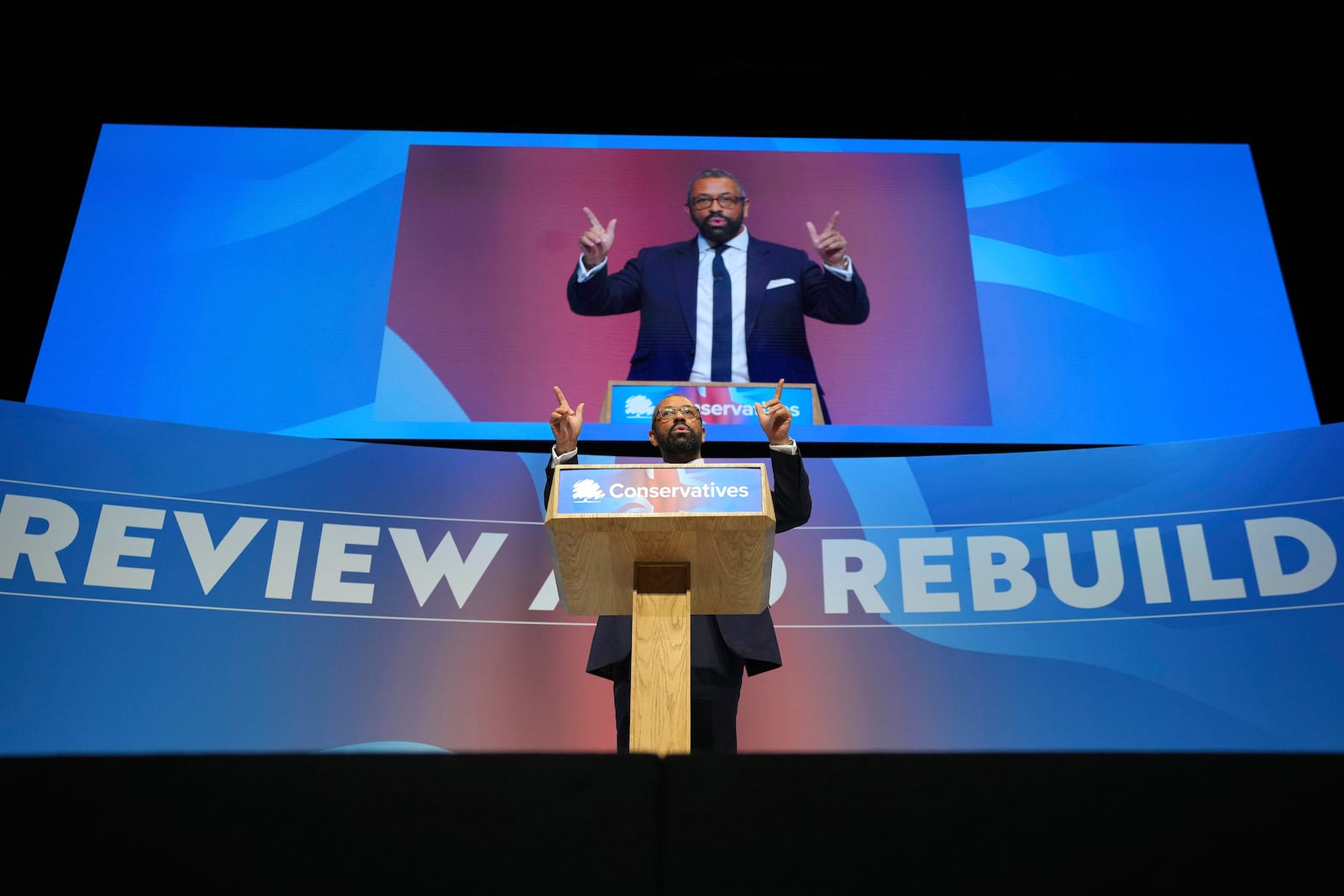 Conservative leadership candidate James Cleverly addresses members during the Conservative Party Conference at the International Convention Centre in Birmingham, England, Wednesday, Oct. 2, 2024.(AP Photo/Kin Cheung)