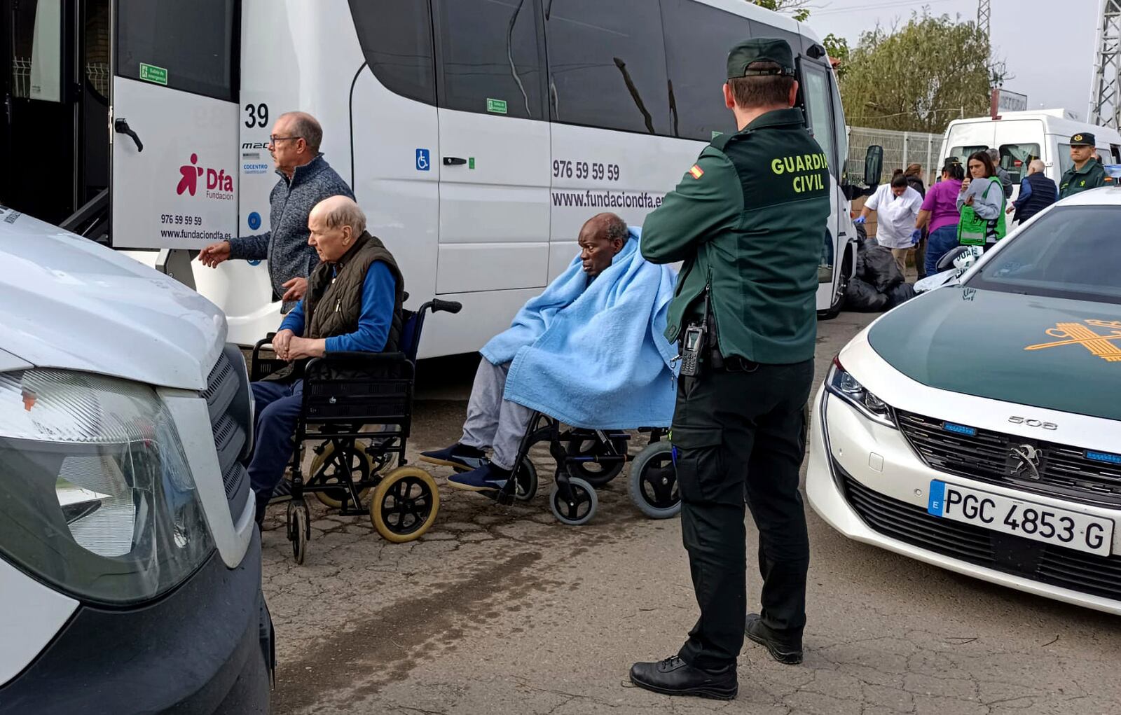 Residents are moved out of the nursing home where least 10 people have died in a fire in Zaragoza, Spain, Friday, Nov. 15, 2024. (AP Photo/Ferran Mallol)