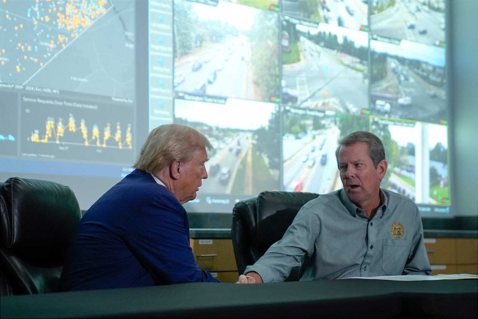 Republican presidential nominee former President Donald Trump talks with Georgia Gov. Brian Kemp during a briefing at the Columbia County Emergency Management Agency as he visits areas impacted by Hurricane Helene, Friday, Oct. 4, 2024, in Evans, Ga. (AP Photo/Evan Vucci)