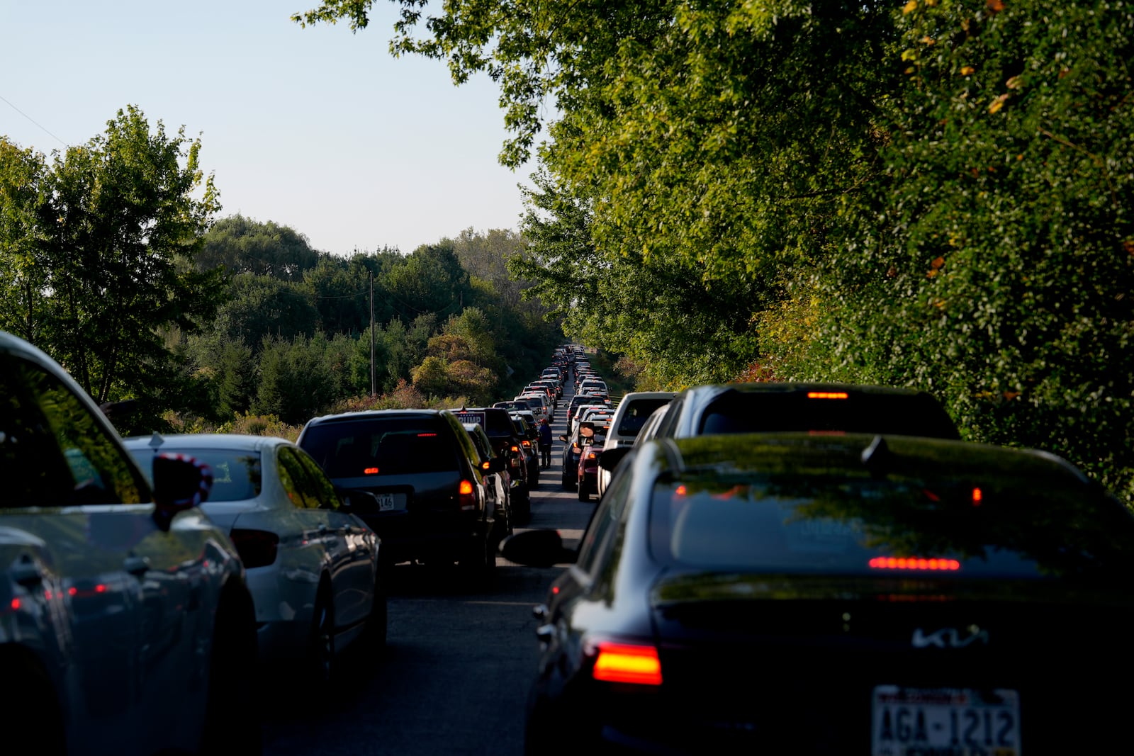 Cars wait in traffic to enter a campaign rally for Republican presidential nominee former President Donald Trump at Dodge County Airport, Sunday, Oct. 6, 2024, in Juneau, Wis. (AP Photo/Julia Demaree Nikhinson)