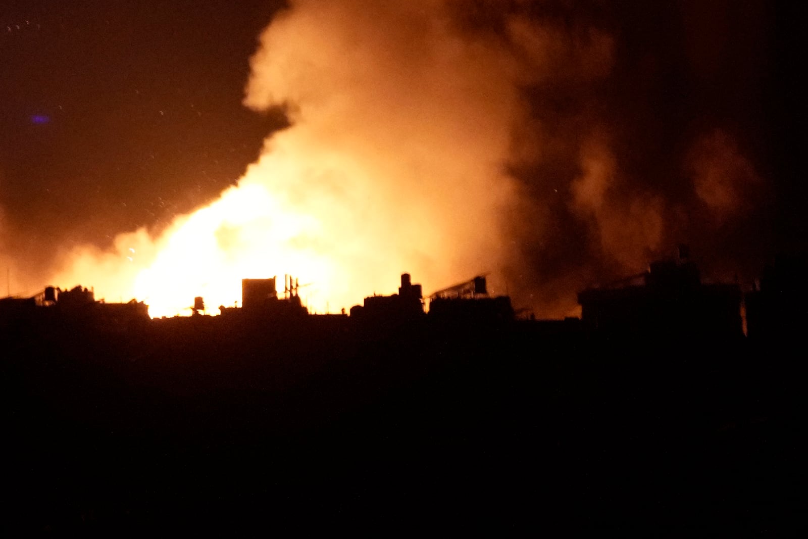 Flames and smoke rise from an Israeli airstrike in Dahiyeh, Beirut, Lebanon, early Sunday, Oct. 6, 2024. (AP Photo/Hussein Malla)