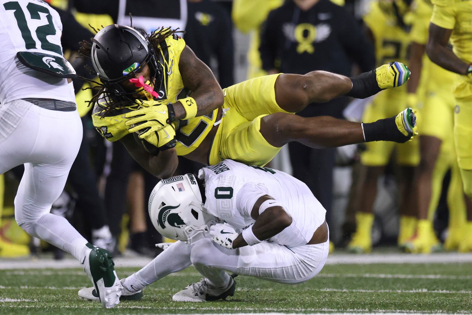 Oregon running back Jordan James, top right, collides with Michigan State defensive back Charles Brantley (0) during the first half of an NCAA college football game, Friday, Oct. 4, 2024, in Eugene, Ore. (AP Photo/Amanda Loman)