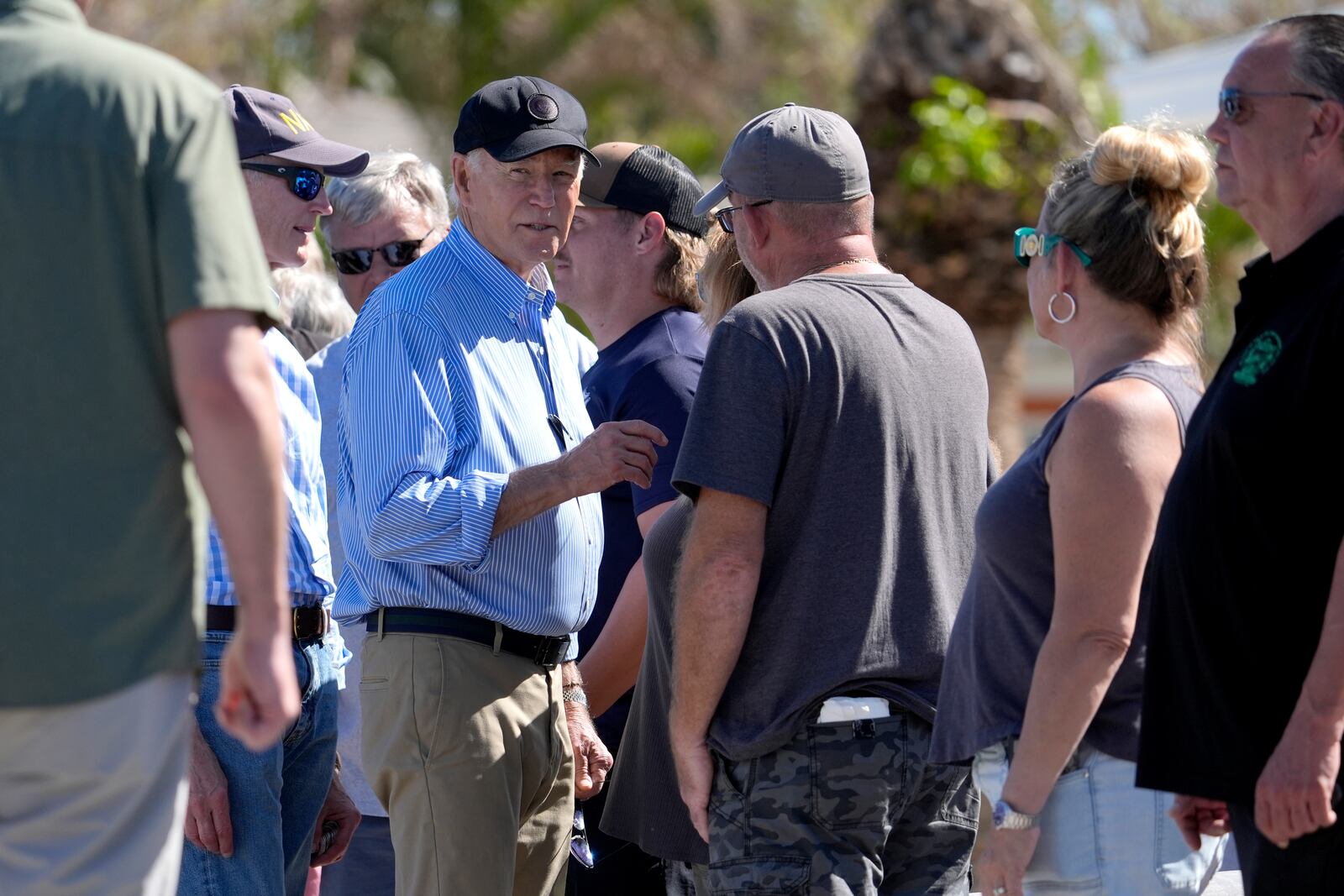 President Joe Biden, second left, speaks with residents and federal, state, and local officials in St. Pete Beach, Fla., during a tour of areas affected by Hurricane Milton, Sunday, Oct. 13, 2024. (AP Photo/Manuel Balce Ceneta)