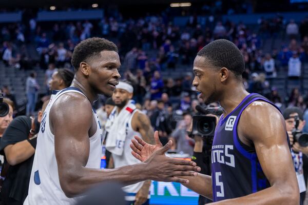 Minnesota Timberwolves guard Anthony Edward, left, talks with Sacramento Kings guard De'Aaron Fox after an Emirates NBA Cup basketball game Friday, Nov. 15, 2024, in Sacramento, Calif. (AP Photo/Sara Nevis)